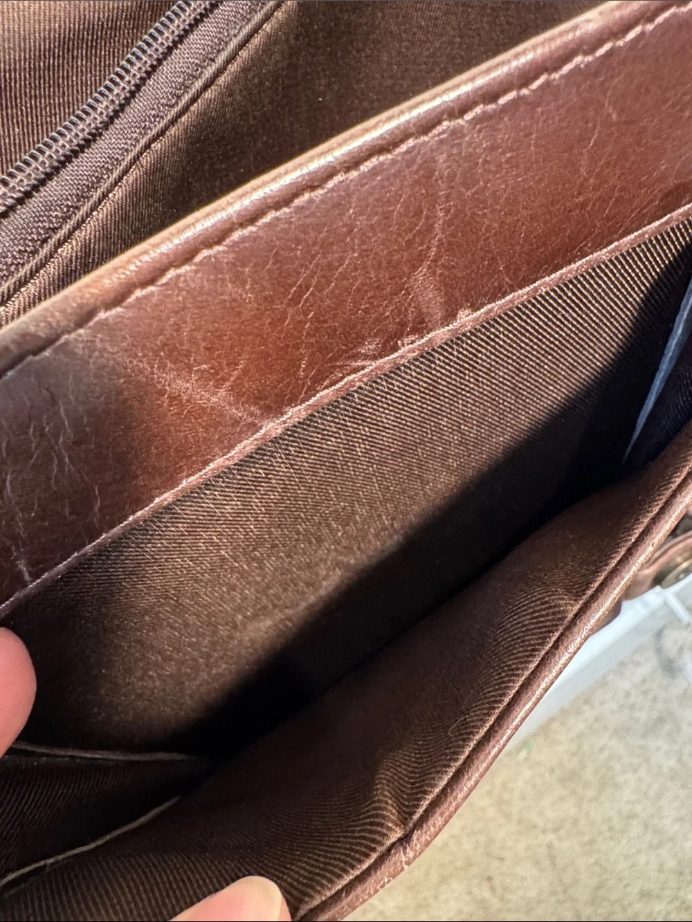 Wilson’s Leather chocolate brown messenger bag with webbed adjustable strap.